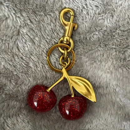 Golden Cherry Keychain Charm — Shiny Resin & Metal Bag Accessory, Elegant Gift for Women
